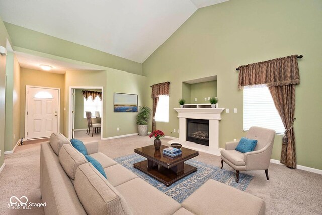 2342 Sheek Rd, Greenwood, IN 46143 - carpeted living room with baseboards, a glass covered fireplace, healthy amount of natural light, and high vaulted ceiling