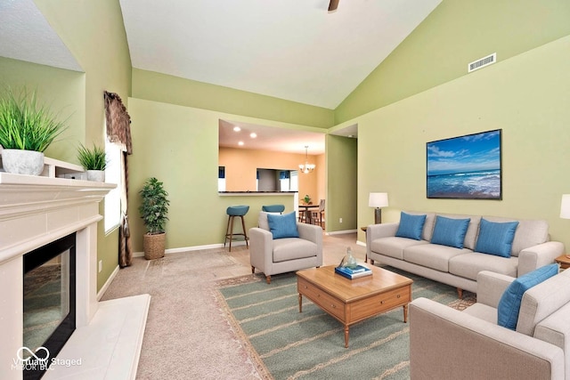 2342 Sheek Rd, Greenwood, IN 46143 - carpeted living area featuring lofted ceiling, baseboards, a glass covered fireplace, and a chandelier