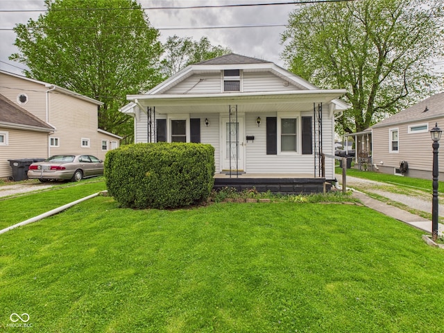 view of front of house with a porch and a front lawn