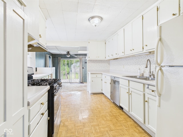 kitchen with light countertops, stainless steel appliances, white cabinetry, and a sink