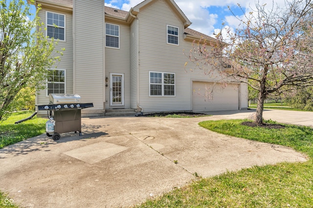 15329 Smithfield Dr, Westfield, IN 46074 - rear view of house with a garage, a shingled roof, and driveway