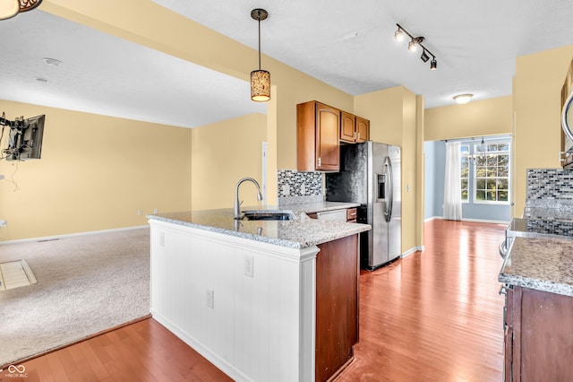 15329 Smithfield Dr, Westfield, IN 46074 - kitchen featuring a sink, backsplash, stainless steel appliances, and light wood finished floors