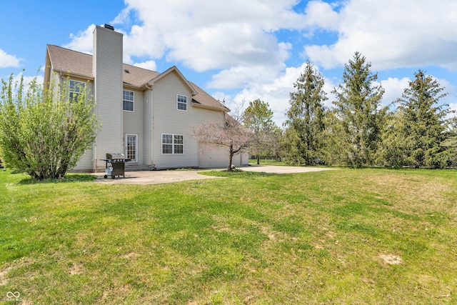 15329 Smithfield Dr, Westfield, IN 46074 - back of house featuring a yard, a patio, and a chimney