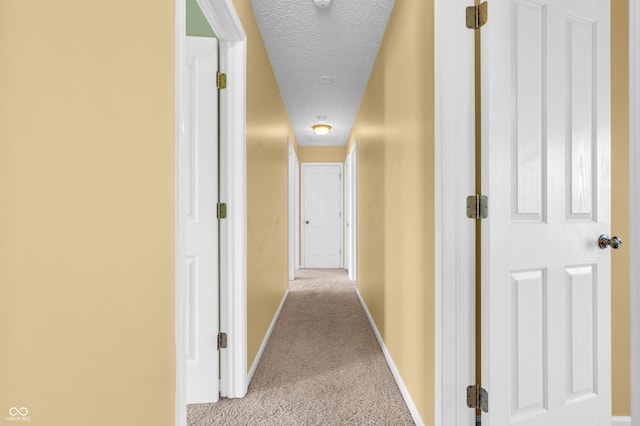 15329 Smithfield Dr, Westfield, IN 46074 - hallway featuring a textured ceiling, baseboards, and light colored carpet