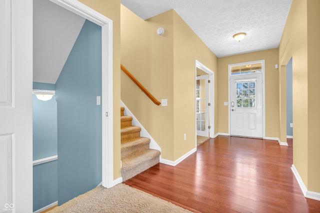 15329 Smithfield Dr, Westfield, IN 46074 - foyer featuring a textured ceiling, baseboards, wood finished floors, and stairway
