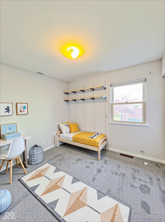 carpeted bedroom with baseboards and visible vents