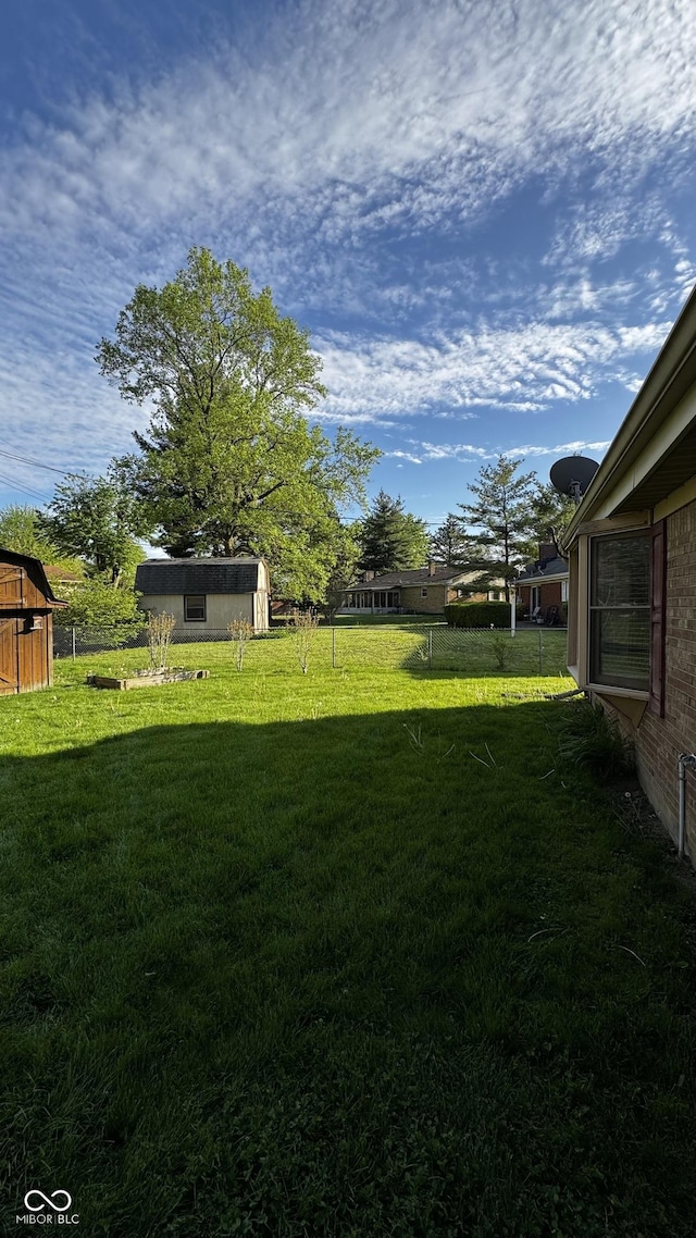 view of yard with an outbuilding and a storage shed