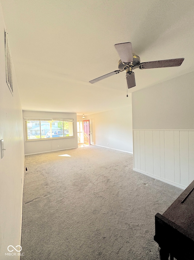 unfurnished room with baseboards, carpet, a ceiling fan, and visible vents
