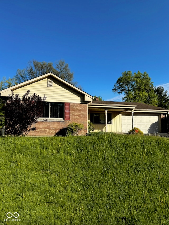 view of front facade with brick siding, a garage, and board and batten siding