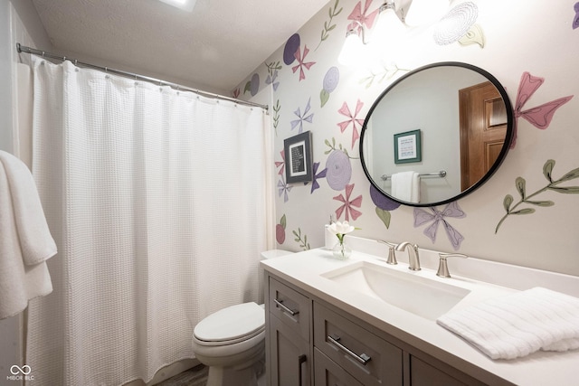 bathroom with toilet, vanity, wallpapered walls, and a shower with shower curtain