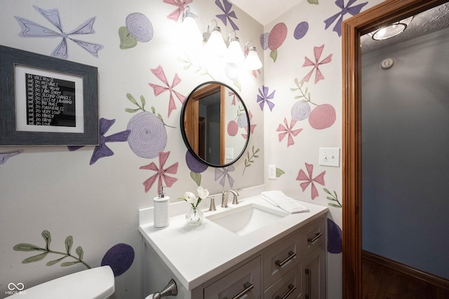 bathroom with toilet and vanity