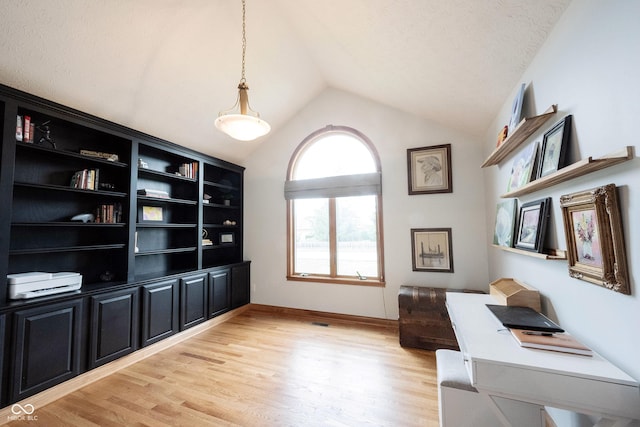 home office featuring lofted ceiling and light wood-style floors