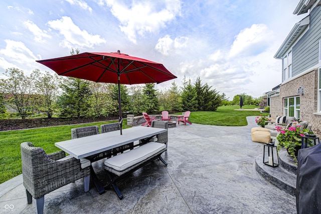view of patio with outdoor dining area and an outdoor fire pit