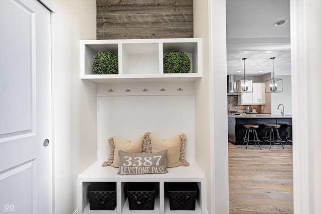 mudroom featuring a sink, recessed lighting, and wood finished floors