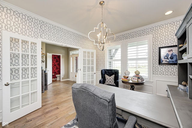 office with crown molding, an inviting chandelier, french doors, and wallpapered walls