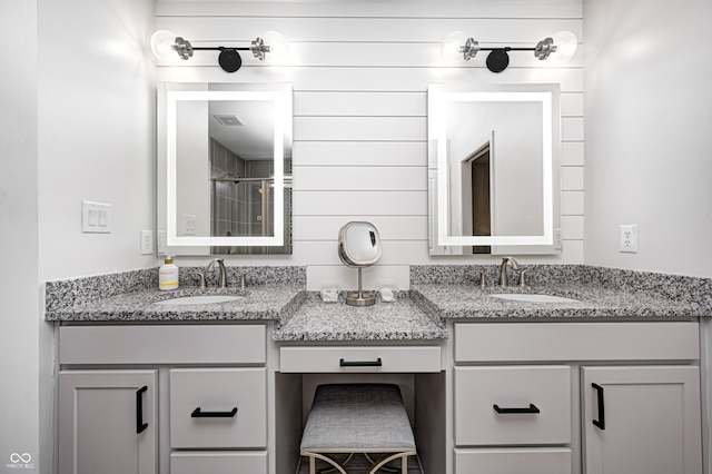 full bathroom with a sink, double vanity, and visible vents