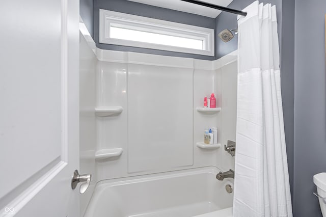 bathroom featuring shower / bath combo and toilet