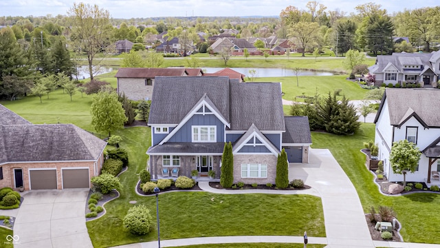 drone / aerial view featuring a residential view and a water view