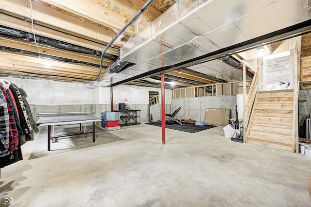 unfinished basement featuring stairway