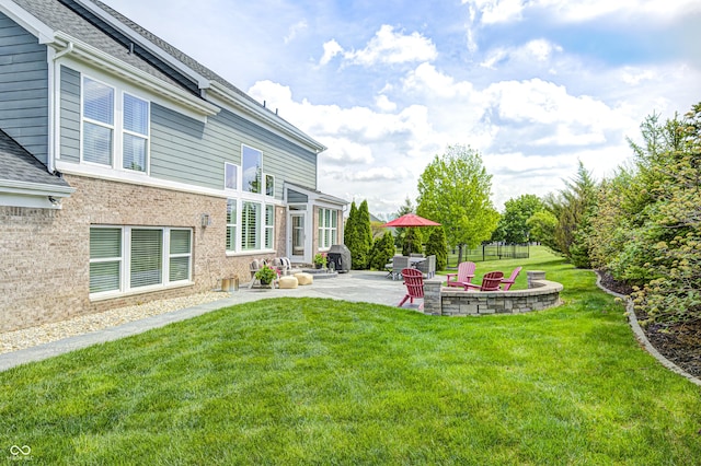 view of yard featuring a fire pit and a patio area