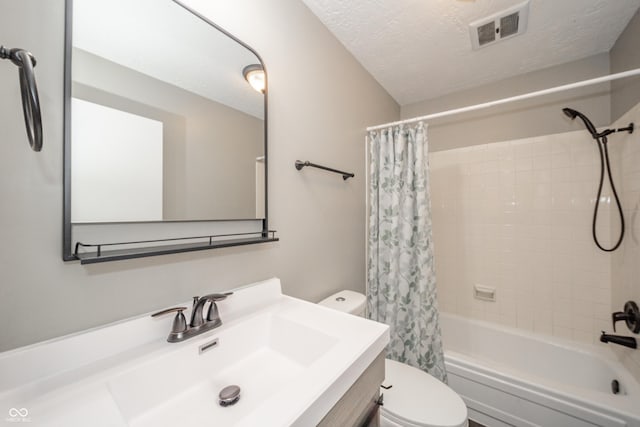 bathroom with vanity, toilet, a textured ceiling, shower / bath combination with curtain, and visible vents
