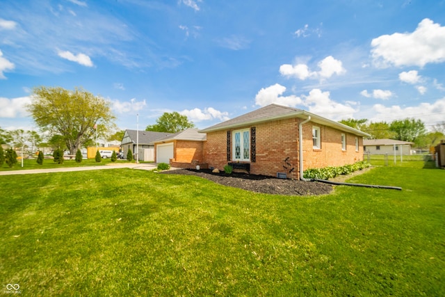 view of property exterior featuring a yard, brick siding, driveway, and fence