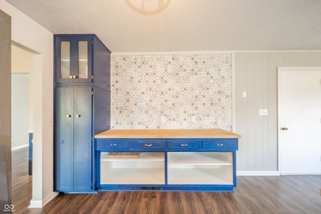 interior space with dark wood-style flooring, baseboards, and a textured ceiling