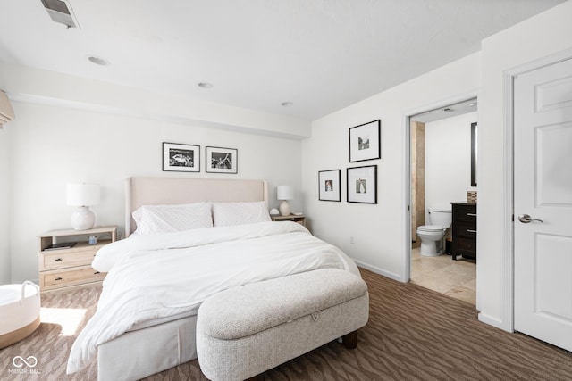 carpeted bedroom with baseboards and ensuite bathroom