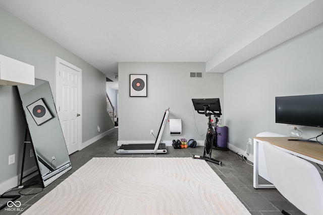 office space with baseboards and visible vents