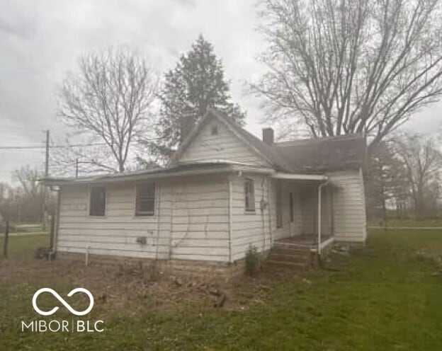 view of home's exterior with a yard and a chimney