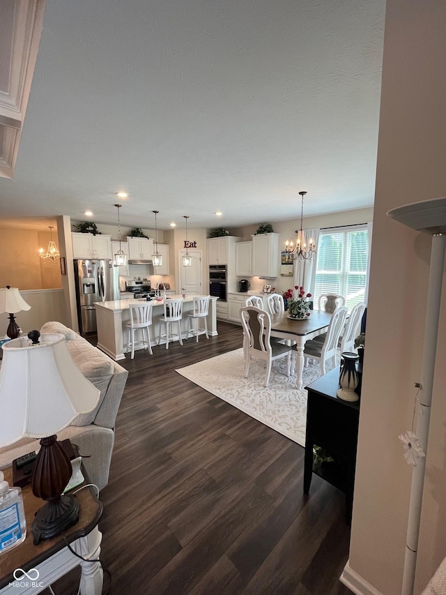 living room with recessed lighting, dark wood finished floors, and a chandelier