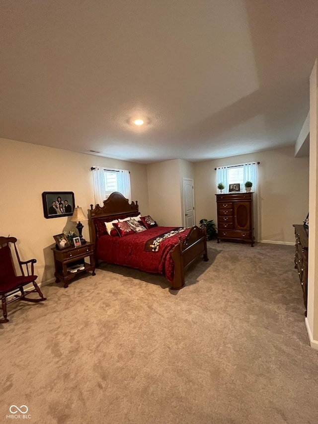 bedroom featuring carpet floors and baseboards