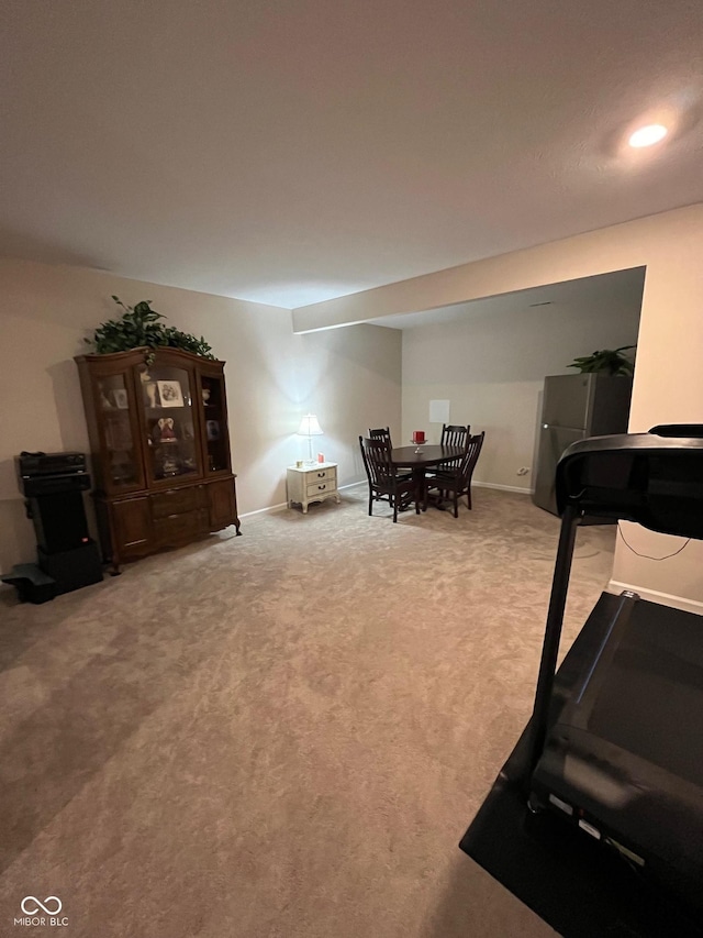 carpeted dining room featuring baseboards