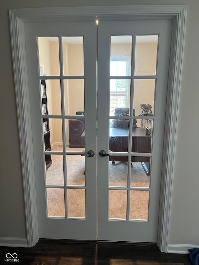 entryway with french doors, baseboards, and wood finished floors