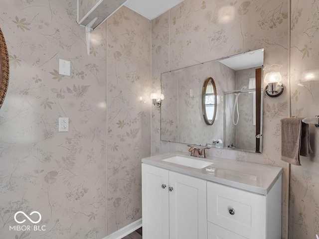 full bathroom with a shower stall and vanity
