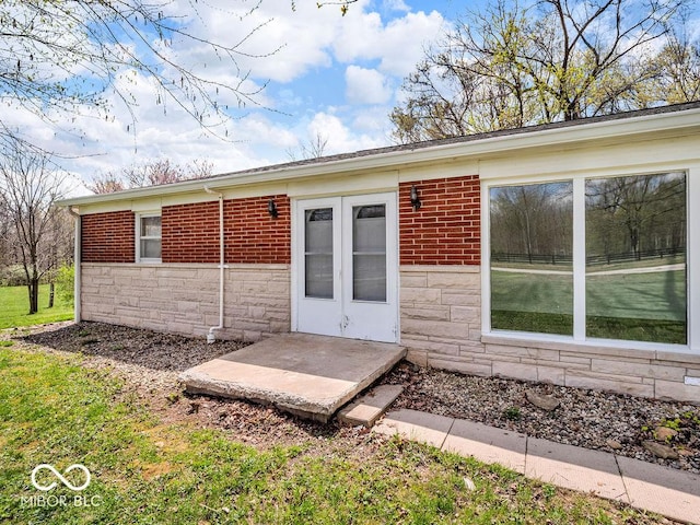 entrance to property with stone siding