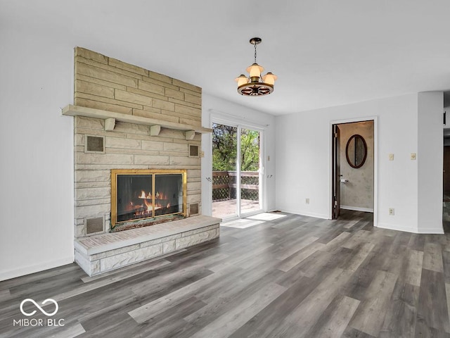 unfurnished living room featuring baseboards, a fireplace, and wood finished floors