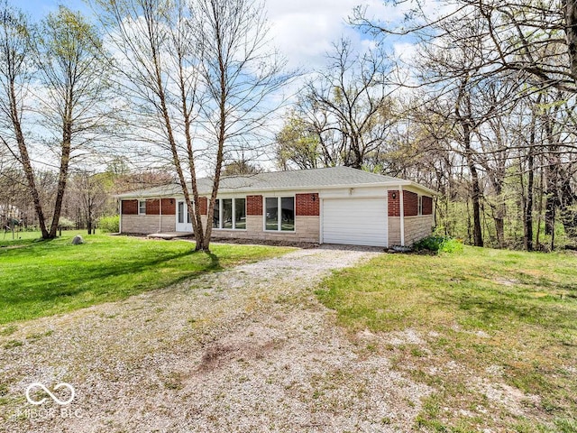single story home with dirt driveway, an attached garage, a front yard, and brick siding