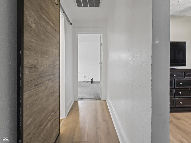 1401 E 24th St, Muncie, IN 47302 - corridor with wood finished floors and a barn door