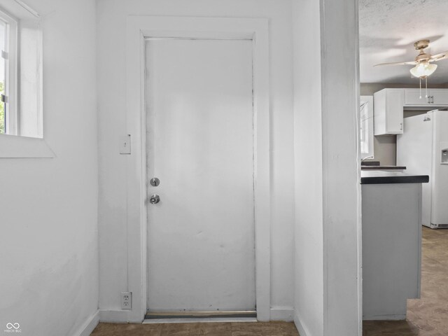 1401 E 24th St, Muncie, IN 47302 - entryway with a ceiling fan and baseboards