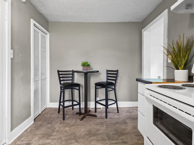 1401 E 24th St, Muncie, IN 47302 - dining space with a textured ceiling and baseboards
