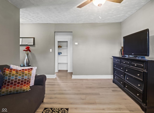 1401 E 24th St, Muncie, IN 47302 - living area with a ceiling fan, a textured ceiling, and light wood finished floors