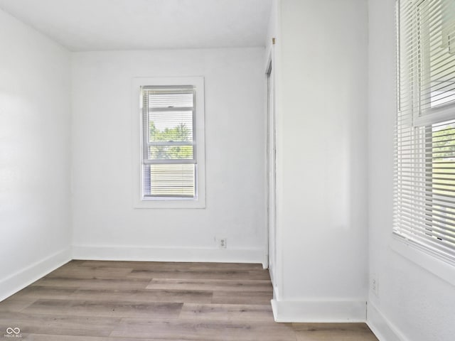 1401 E 24th St, Muncie, IN 47302 - spare room featuring plenty of natural light and wood finished floors