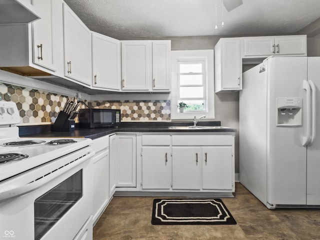 1401 E 24th St, Muncie, IN 47302 - kitchen with white appliances, extractor fan, white cabinets, dark countertops, and decorative backsplash