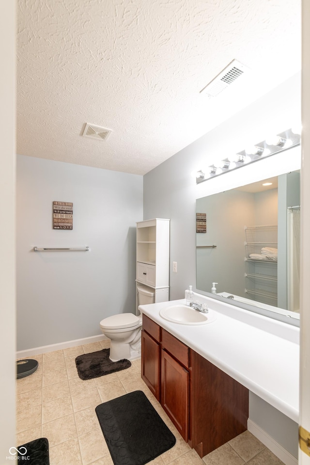 full bathroom featuring vanity, tile patterned flooring, a textured ceiling, and visible vents