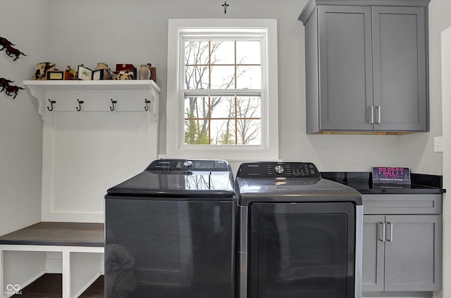 washroom featuring washer and dryer and cabinet space