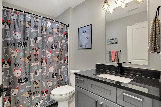 bathroom with vanity, a shower with shower curtain, toilet, and visible vents