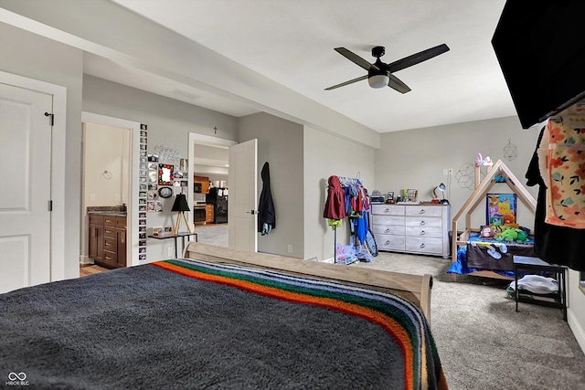 carpeted bedroom with ceiling fan and connected bathroom