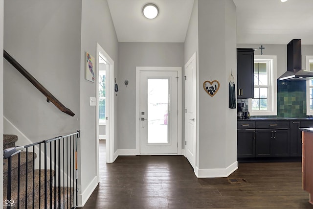 entrance foyer with baseboards, dark wood finished floors, visible vents, and stairway