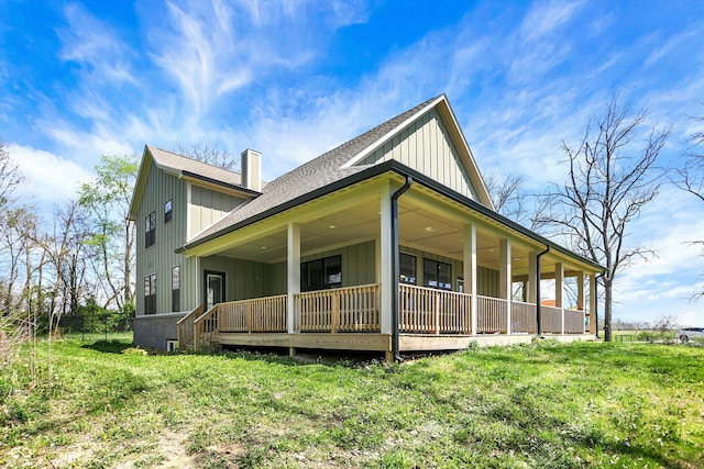 view of front of home featuring a shingled roof, board and batten siding, and covered porch